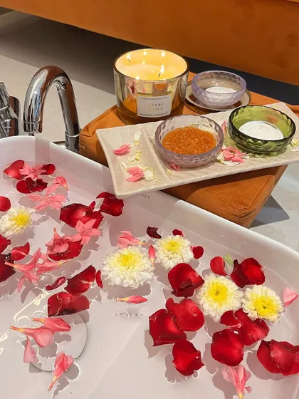 A close-up of the details that make our pedicure spa special. I use natural ingredients, fresh flower petals, and soothing candles to create a truly sensory experience that calms your mind while treating your feet.