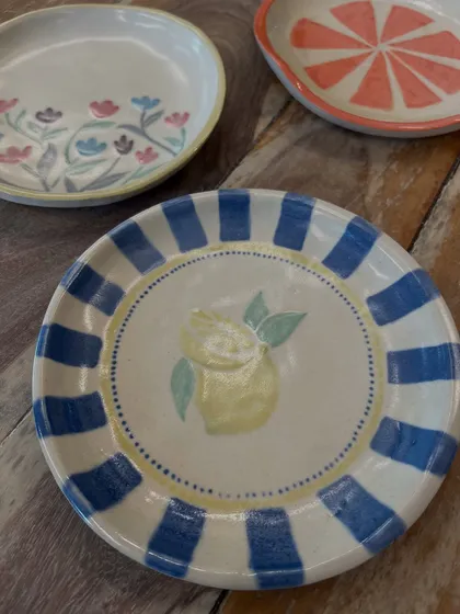 Just look at these beautiful plates painted by people in our workshops. It's amazing to see everyone's unique style come to life with color and glaze.