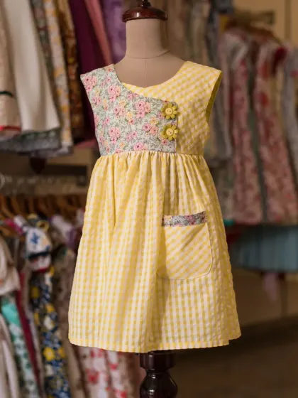 Another view of the yellow gingham and floral dress, showing how the different patterns and textures work together to create a charming, one-of-a-kind look.