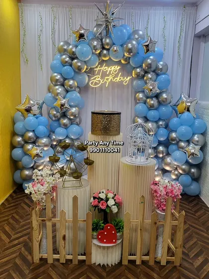This is an example of a complete birthday setup in my own party hall in Kanakapura. It includes a full balloon arch, pedestals for the cake, a picket fence, and other props, all available at a budget-friendly price.