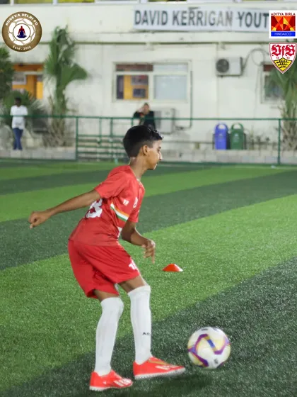 Dribbling around cones is a simple but effective drill for improving agility and ball handling. Our players work on these fundamentals daily.