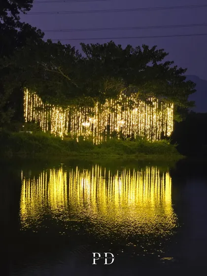 A magical view of the wedding venue at night, with fairy lights on the trees reflecting beautifully on the lake's surface. We ensure the decor is just as stunning after the sun goes down.