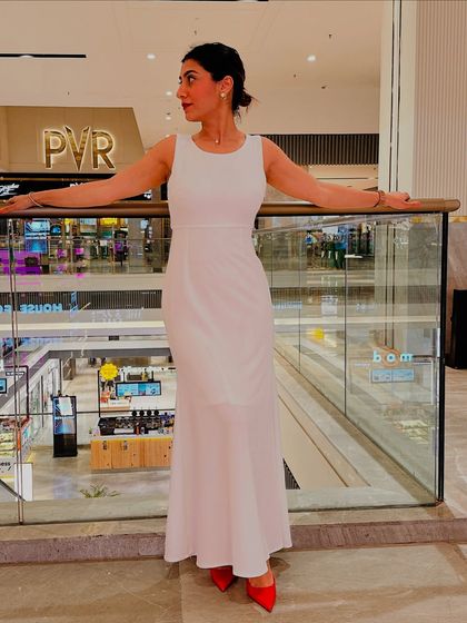 Posing at a mall in my white dress and red heels. This look proves that with the right styling, any piece can become a statement.