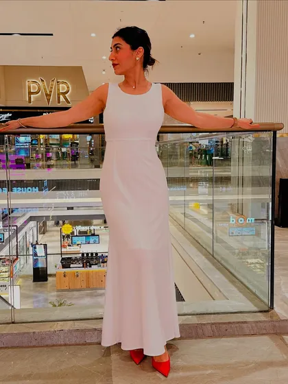 Posing at a mall in my white dress and red heels. This look proves that with the right styling, any piece can become a statement.