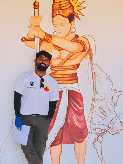 Standing beside the nearly completed mural of a historical warrior, a piece meant to inspire courage and a connection to our roots.