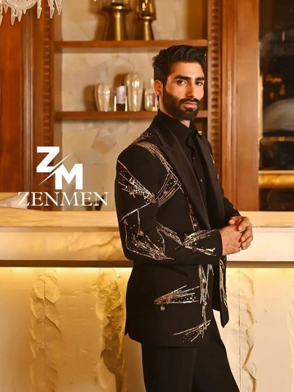 The black and gold sequin tuxedo, styled for a sophisticated evening look. The all-black shirt allows the gold embroidery to be the star of the show.