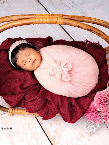 A wider shot of the pink-themed basket setup against a white wood background.