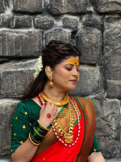 A contemplative shot showing the details of her makeup and jewelry.
