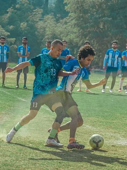 A tense one on one battle for the ball, showing the skill and determination of the players in our corporate league.