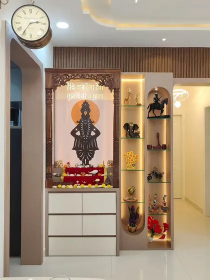 A closer look at a custom-designed pooja unit that has become the spiritual heart of this home. We used a traditional carved wooden frame, back-lit paneling with a sacred motif, and integrated display niches with soft lighting. The unit also includes white drawers for storing pooja essentials, blending devotion with clean, modern design.