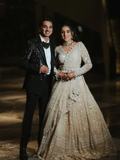 The happy couple looking absolutely gorgeous for their Sangeet. Her embellished gown and glamorous makeup are perfect for a grand celebration.