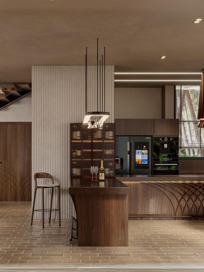 This render shows the kitchen and bar area of the Siori Lilly Villas. The design uses a rich walnut wood and a curved bar with intricate detailing, creating a sophisticated space for entertaining.
