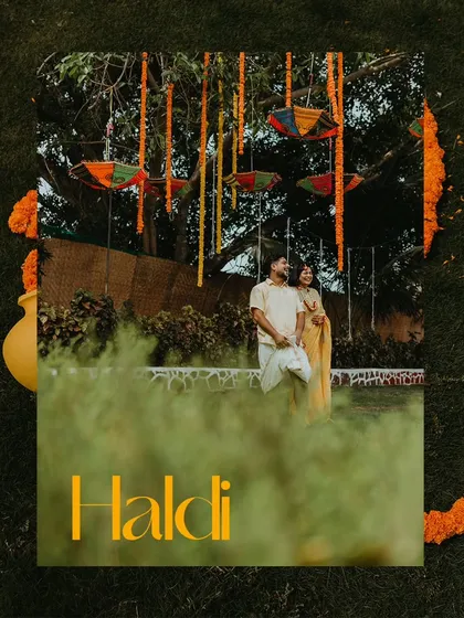 An artistic shot of the couple standing under a tree decorated for their Haldi, framed by greenery.