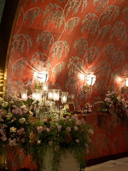 The combination of warm lighting from the sconces and candelabras created a welcoming yet grand entryway for the reception.