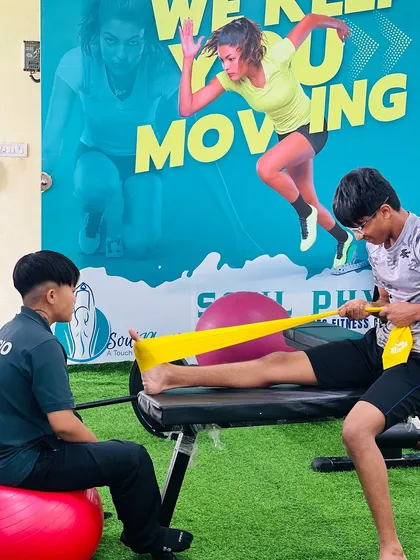 "Let the beauty of what you love be what you do." A physiotherapist works with a young athlete, demonstrating our passion for helping clients achieve their goals.