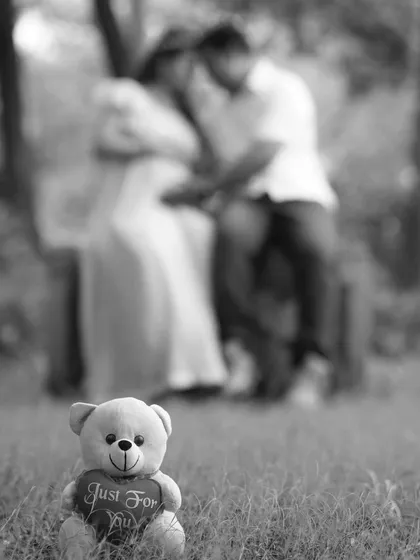 I enjoy getting creative with composition. Here, a small teddy bear sits in the foreground while the expecting couple shares a moment in the background, telling a story of the new life they are waiting for.