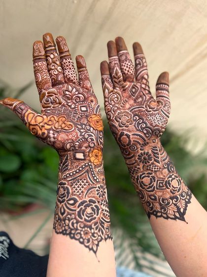 Another angle of the heavy henna pattern, showing the details on the back of the hands.