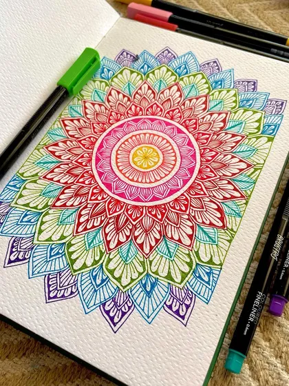 Another angle of my colorful fineliner mandala, with the pens that created it. Using a variety of colors helps bring so much life and dimension to the artwork.