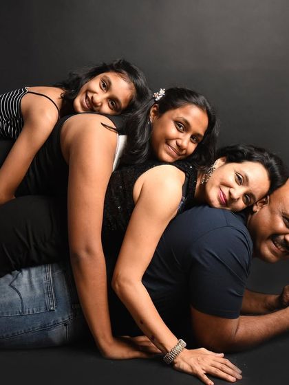 A fun and playful "family stack" pose. These sessions are all about creating happy memories and photos that show your family's unique spirit.