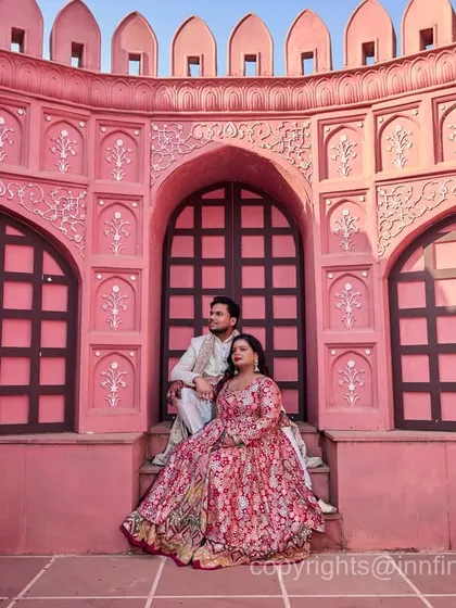 The intricate details and rich color of our pink palace set create a stunning backdrop for a regal couple portrait.