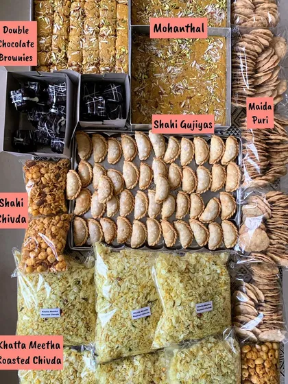 A beautiful festive spread for Raksha Bandhan, featuring a mix of my traditional sweets and modern baked goods. This shows the variety I offer, including Shahi Gujiyas, Mohanthal, Double Chocolate Brownies, and savory chivda.