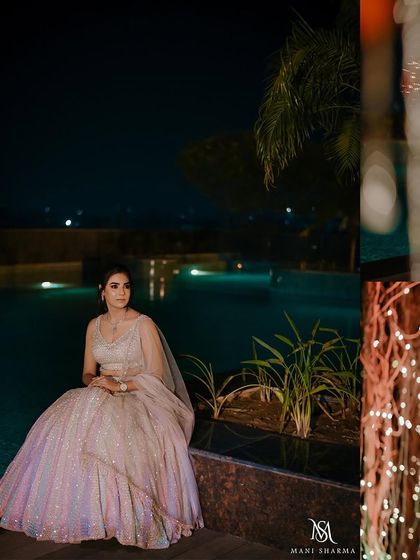 A serene portrait of the bride sitting by the pool at night.