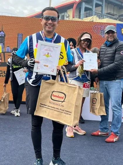A member receiving his prize on the podium. Hard work pays off.