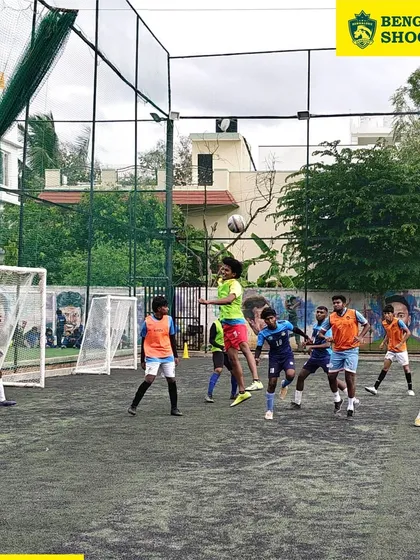 It's all about game-time decisions. Here, our young footballers compete for an aerial ball during a practice match, a crucial skill we develop through constant heading sessions and match simulations.