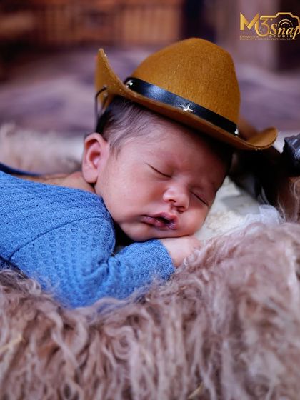 Adding a tiny cowboy hat brings a touch of playful charm to this newborn portrait. I have a wide variety of cute props to match any theme you can imagine.