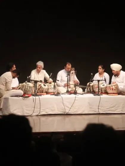 The full ensemble on stage during the tribute to Zakir bhai. The sight of multiple tabla players performing in unison is a powerful spectacle.