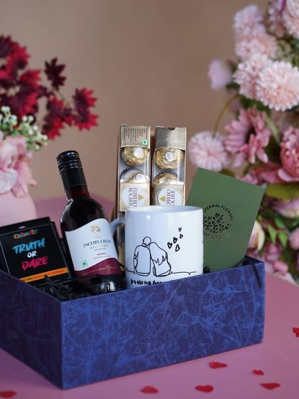 My 'A Toast to Love' hamper, perfect for Valentine's Day or an anniversary. It features a personalized mug, non-alcoholic wine, chocolates, and a fun 'Truth or Dare' game for the couple.
