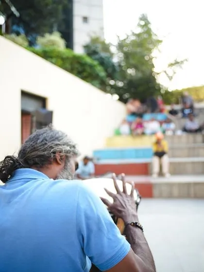A musician plays the djembe, providing a soulful soundtrack for shoppers at our festival. The amphitheater setting at NIFT is perfect for live performances.