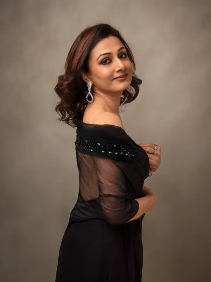 Another look from her session, this time in a sophisticated black dress. It shows her versatile style and the quiet confidence she exudes.