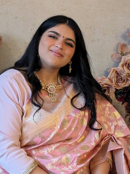 Rhea's serene smile on her special day. The intricate details of her necklace from the Tribe Amrapali collection add a touch of heritage and artistry to her modern bridal look.