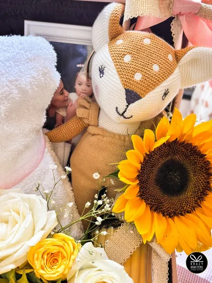 A detail shot focusing on the adorable plush deer toy and the personalized towel, capturing the sweet and gentle theme of this celebrity baby hamper.