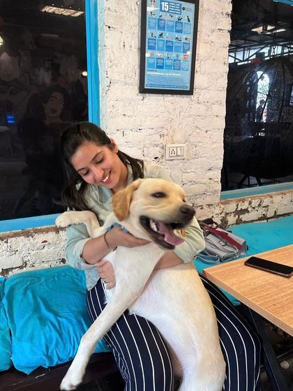 A guest gives her happy Labrador a big hug. The smiles say it all.