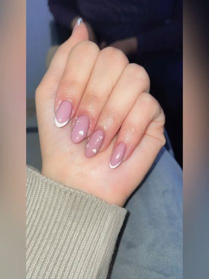 A simple, clean, and classic French manicure with a little heart accent. Sometimes, less is more.