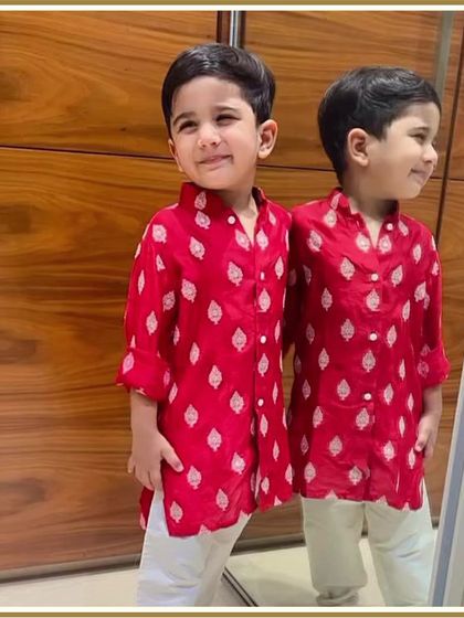 Double the charm. This little one checks himself out in the mirror, looking absolutely adorable in his red printed kurta.