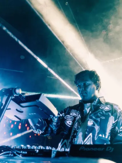 A smoky, atmospheric shot from a techno set. The low light and heavy bass create an intense, immersive experience.