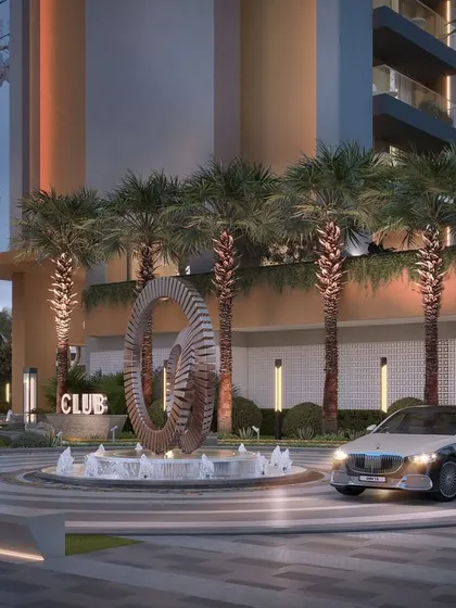 The grand entrance to the club at Gulnaar Zenium, featuring a sculptural centerpiece and elegant driveway, sets a tone of luxury and exclusivity.