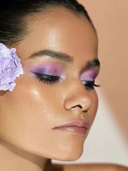 A profile view of the lilac eye makeup, showing how the color is winged out slightly to elongate the eye.