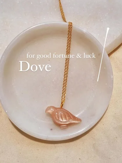 The peach moonstone 'dóve' pendant, a symbol of good fortune and luck.