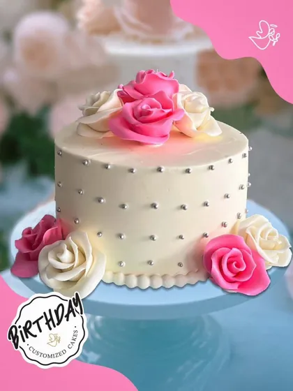 A timelessly elegant cake with pink and white sugar roses and silver pearls. This classic design is perfect for any celebration that calls for a touch of grace.