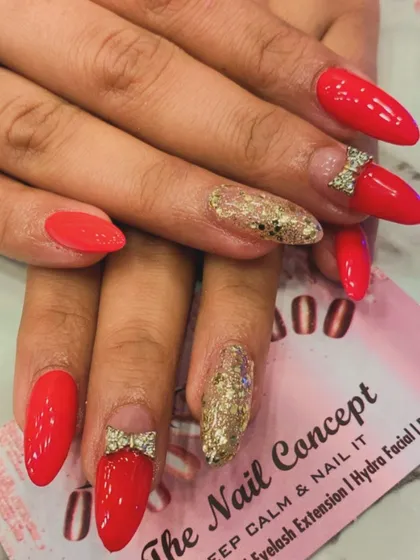 Cute and glamorous, this set features bright red almond nails with a gold glitter accent. The look is completed with adorable 3D rhinestone bows placed at the base of two nails.