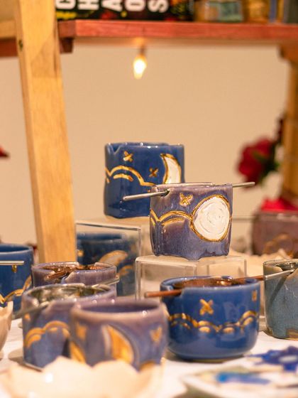 A celestial-themed collection of tea light holders by Tara Maria, featuring moons and stars with gold luster details.