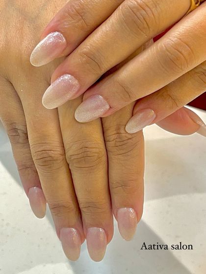 A simple, clean, and elegant manicure using a shimmery nude polish on beautifully shaped oval nails.