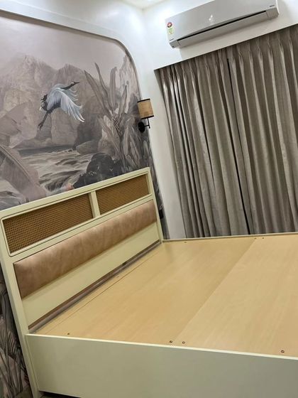 The master bedroom at our Mahagun Moderne project. The stunning wallpaper creates a feature wall behind the custom bed, which includes a cane and cushioned headboard.