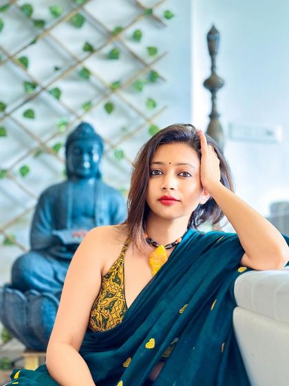 A candid, thoughtful pose. This look proves that sarees can be modern and sexy. It's all about how you drape it and the attitude you wear it with.