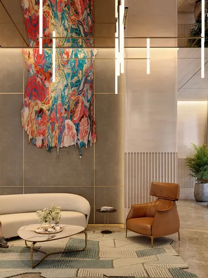 A seating area within the Nagpur lobby, where a dramatic, colorful art piece hangs above a modern sofa. The space showcases an impeccable attention to detail with a palette that celebrates the essence of slow living and curated luxury.