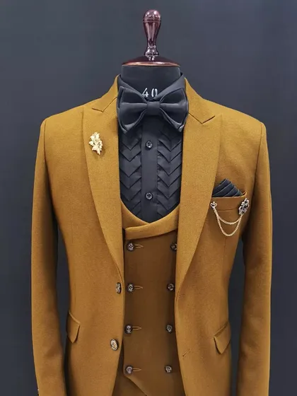 What better way to spice up an occasion than with a suit? This mustard yellow three-piece suit, paired with a black shirt, is designed to make you look and feel royal.